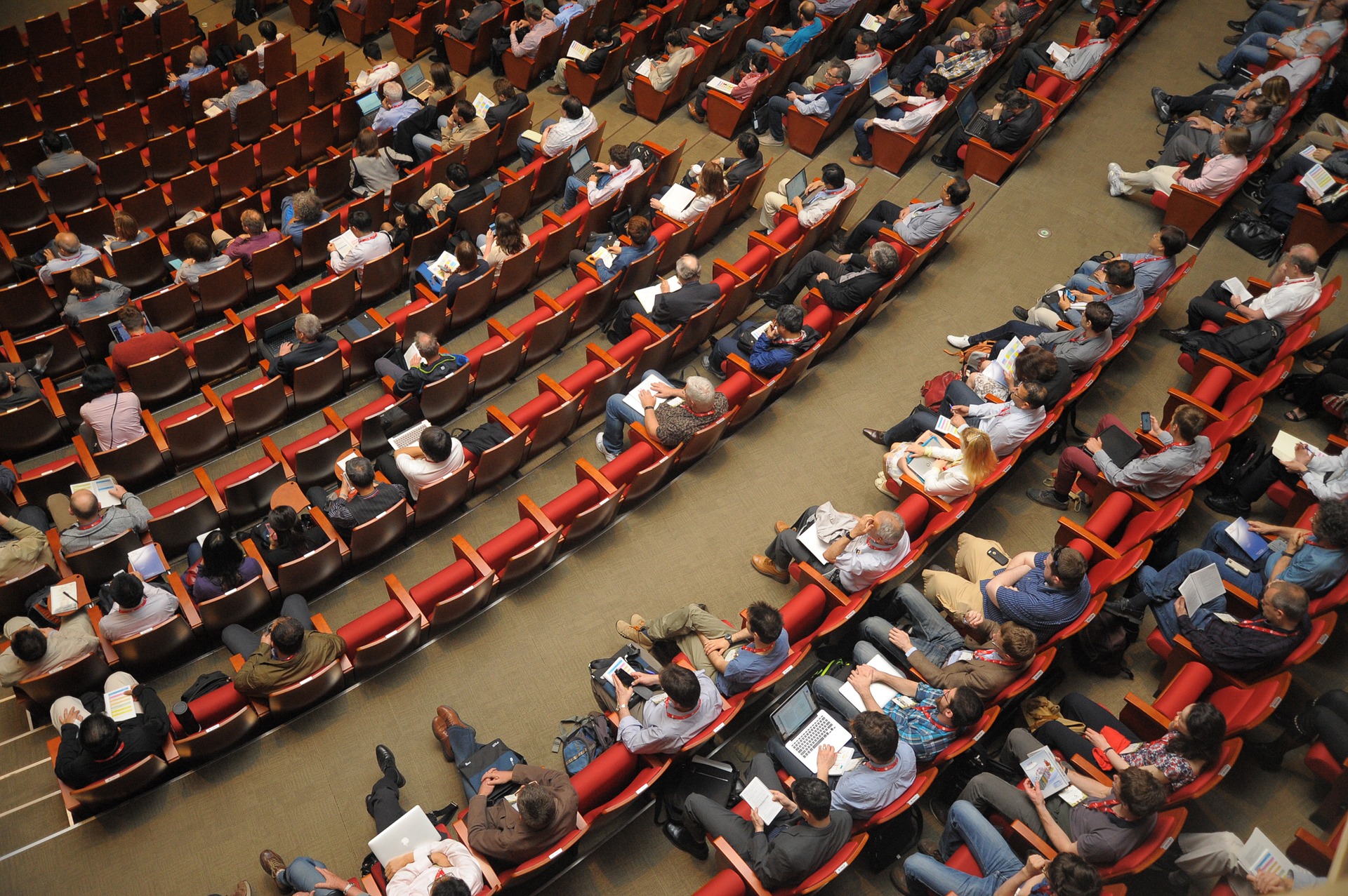View from above of audience members seated in a large auditorium