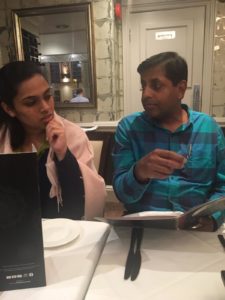 Two of the delegation considering the menu at a restaurant table